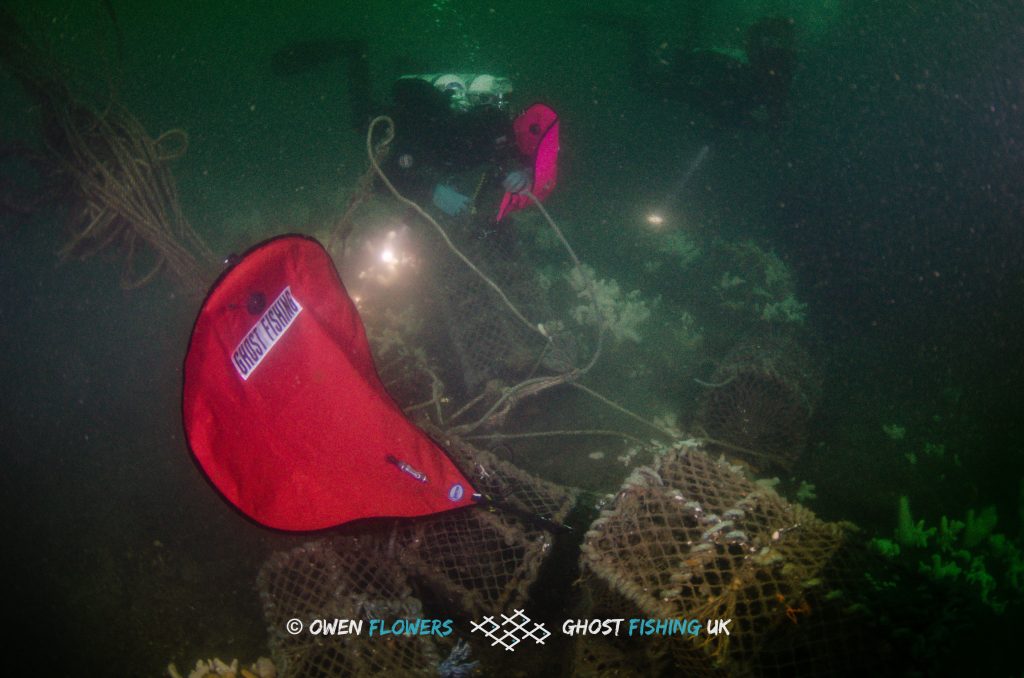 Diver attaching lift bags to creels